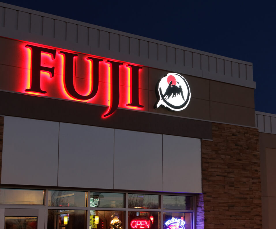 Fuji red halo lit channel letters with custom shaped logo on building grand forks nd