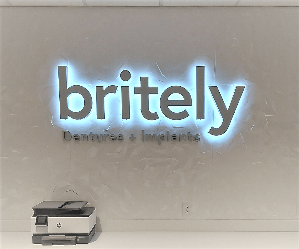 Interior Logo Britely Dentures and Implants back lit sign