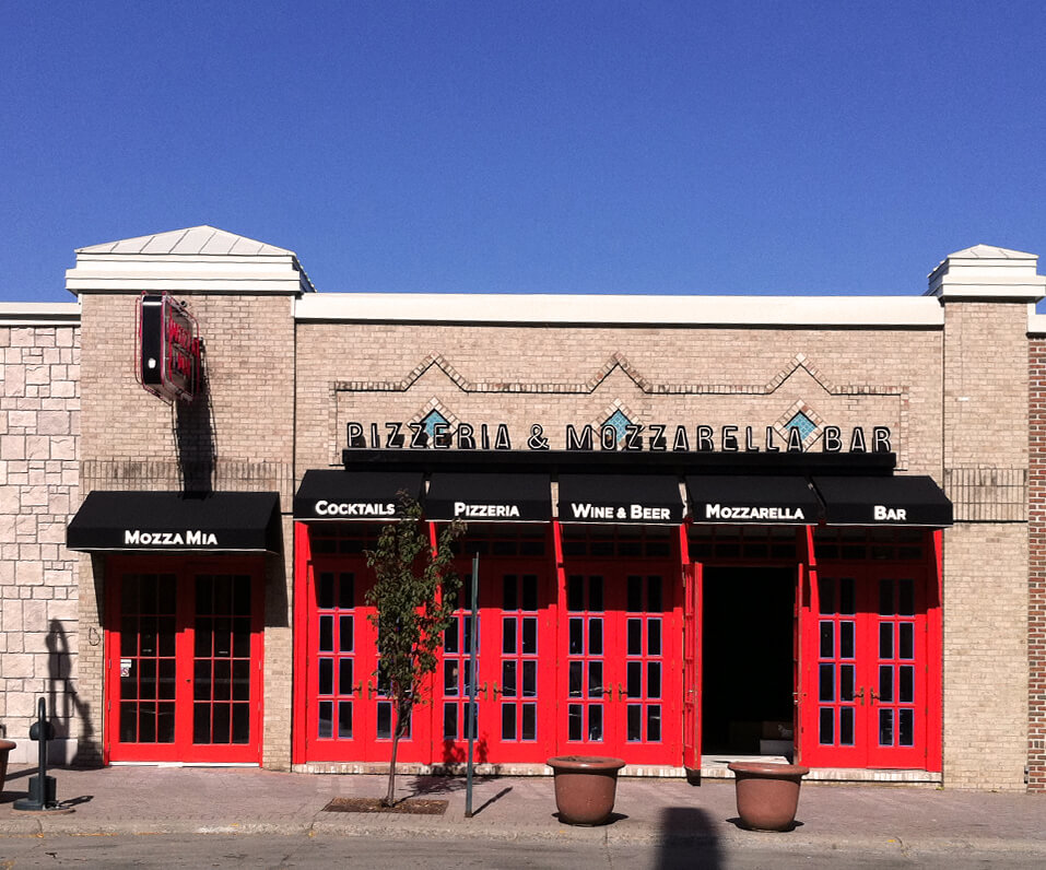 Mozza Mia Pizzeria St Paul MN Building front with Red doors and black custom awnings