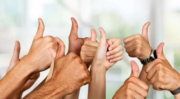 a group of people with thumbs up