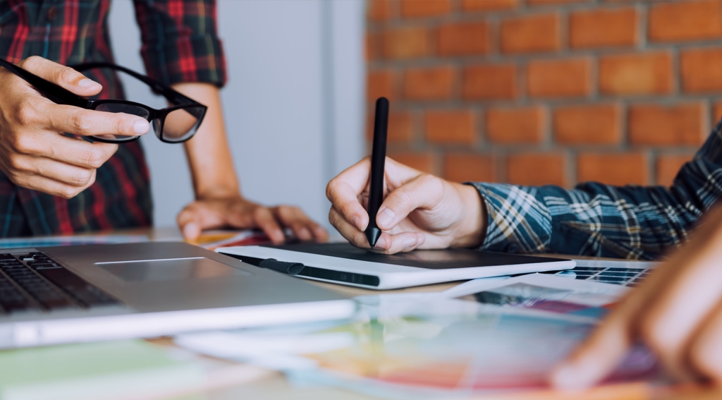 Co-worker working with graphic design in office room together